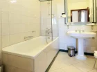 Łazienki wyposażone są w wanny z prysznicami