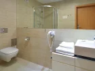 Łazienka apartamentu z kabiną prysznicową i suszarką do włosów