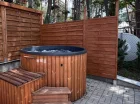 Obok sauny jest jacuzzi, a za płotem park linowy